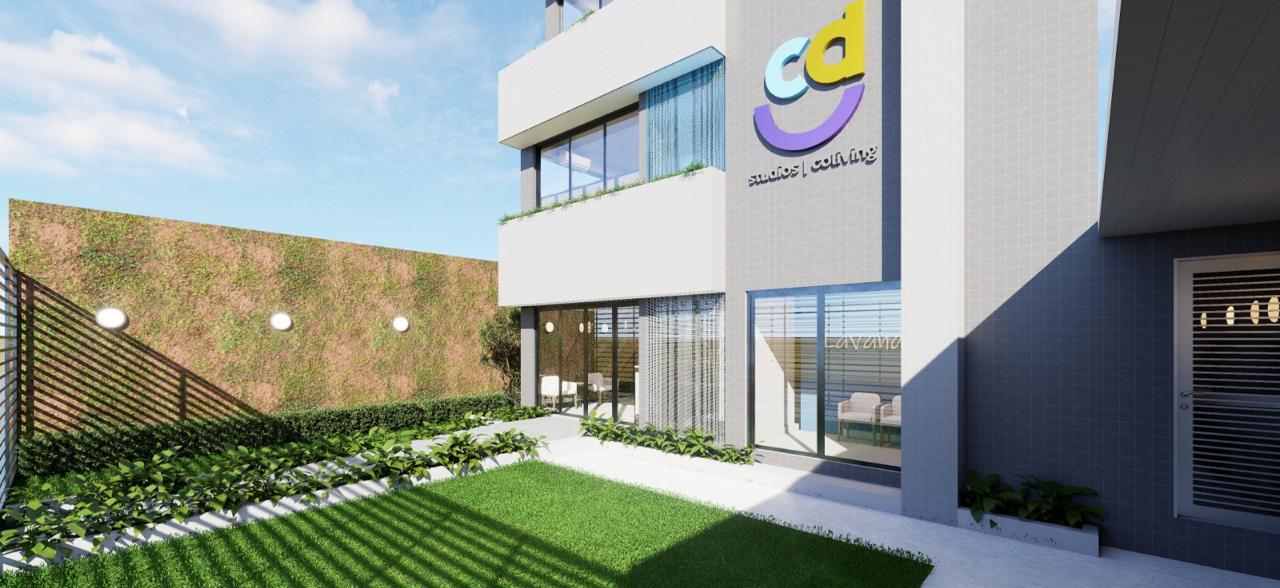 Jardim e fachada do CDU Studios, com parede verde ao lado